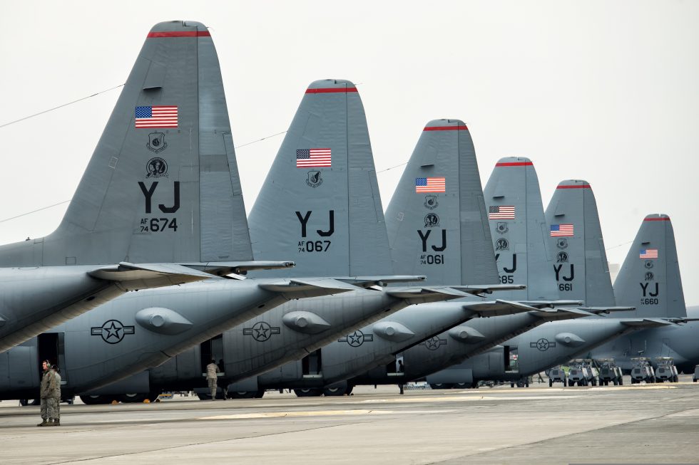 A line of U.S. Air Force C-130 Hercules on the flight line at Yokota Air Base before a large-formation flight.