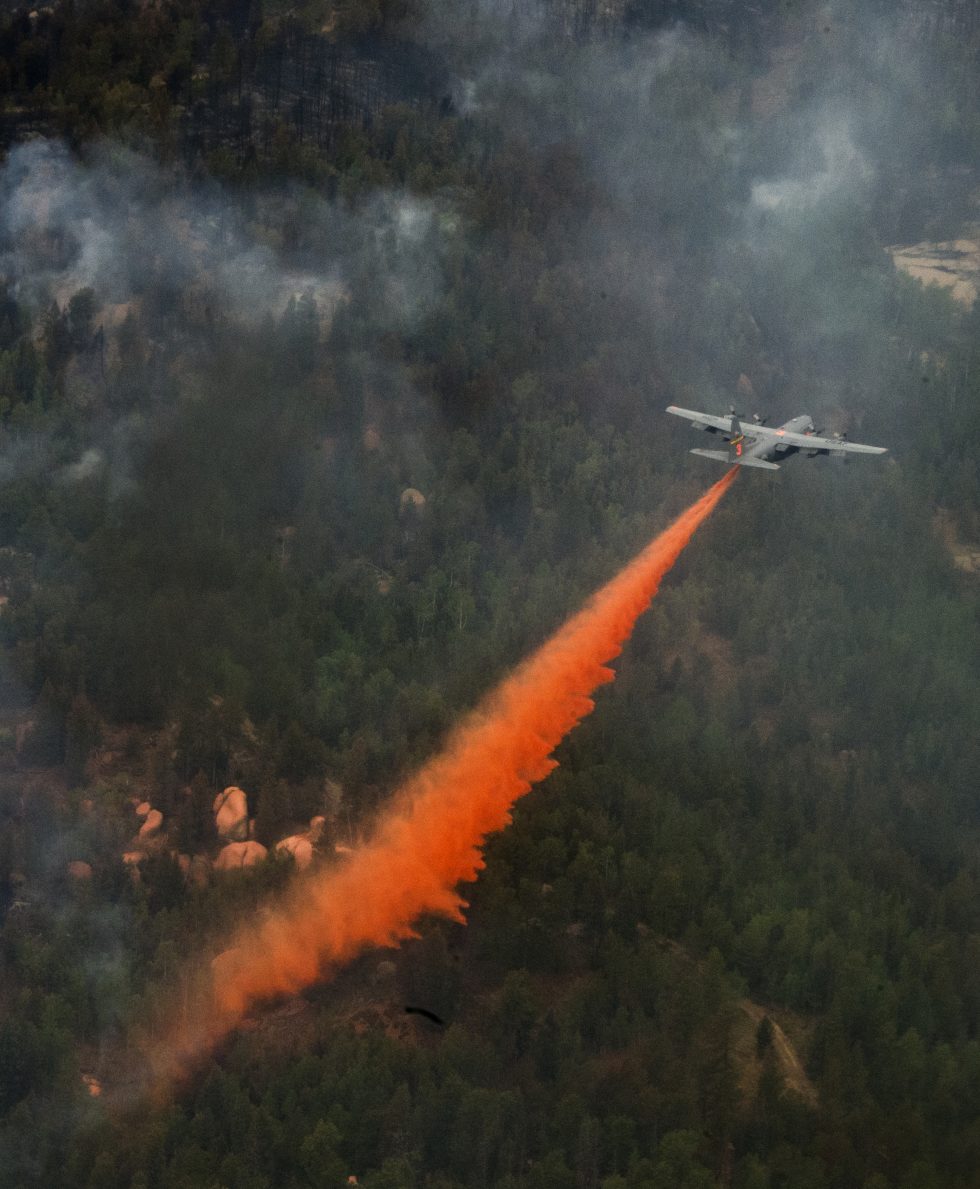 A C-130 Hercules drops fire retardant using the Modular Airborne Fire Fighting System (MAFFS) over the Waldo Canyon fire.