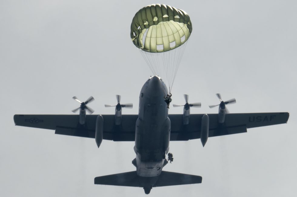 Paratroopers jump from a C-130 Hercules the airborne assault role the aircraft was designed for.