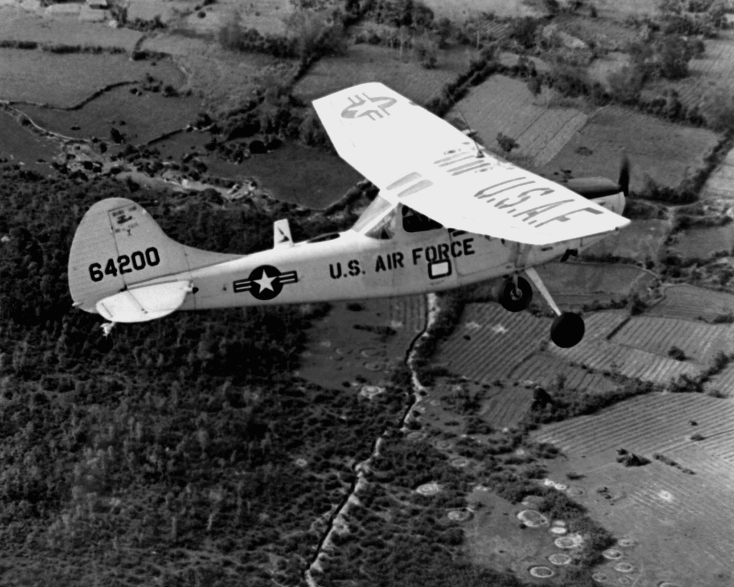 Cessna O-1 Bird Dog forward air control aircraft in flight over Vietnam