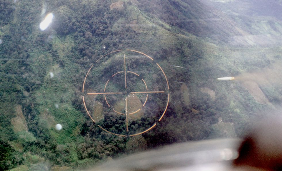 Cockpit view from a Cessna O-2A Skymaster as a marking rocket streaks toward a jungle target in Vietnam, 1969