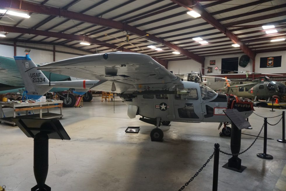 A preserved camouflaged Cessna O-2A Skymaster showing its twin-boom, push-pull layout at the Cavanaugh Flight Museum