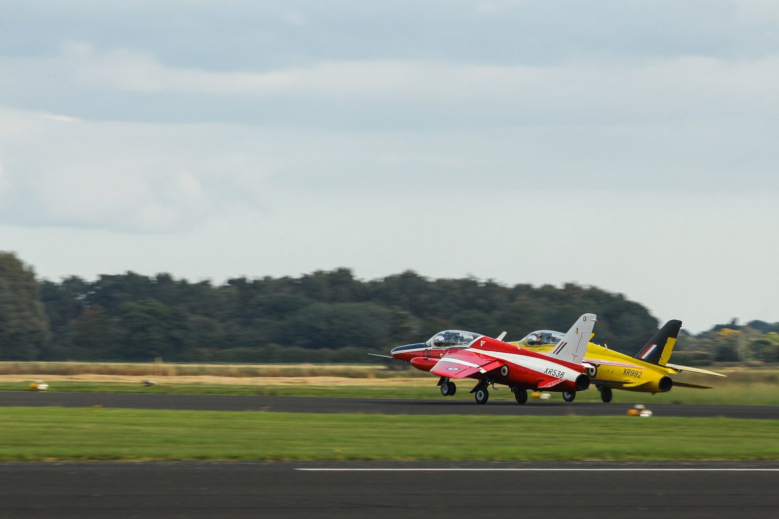 Folland Gnat light jet fighters on the grass in display colours