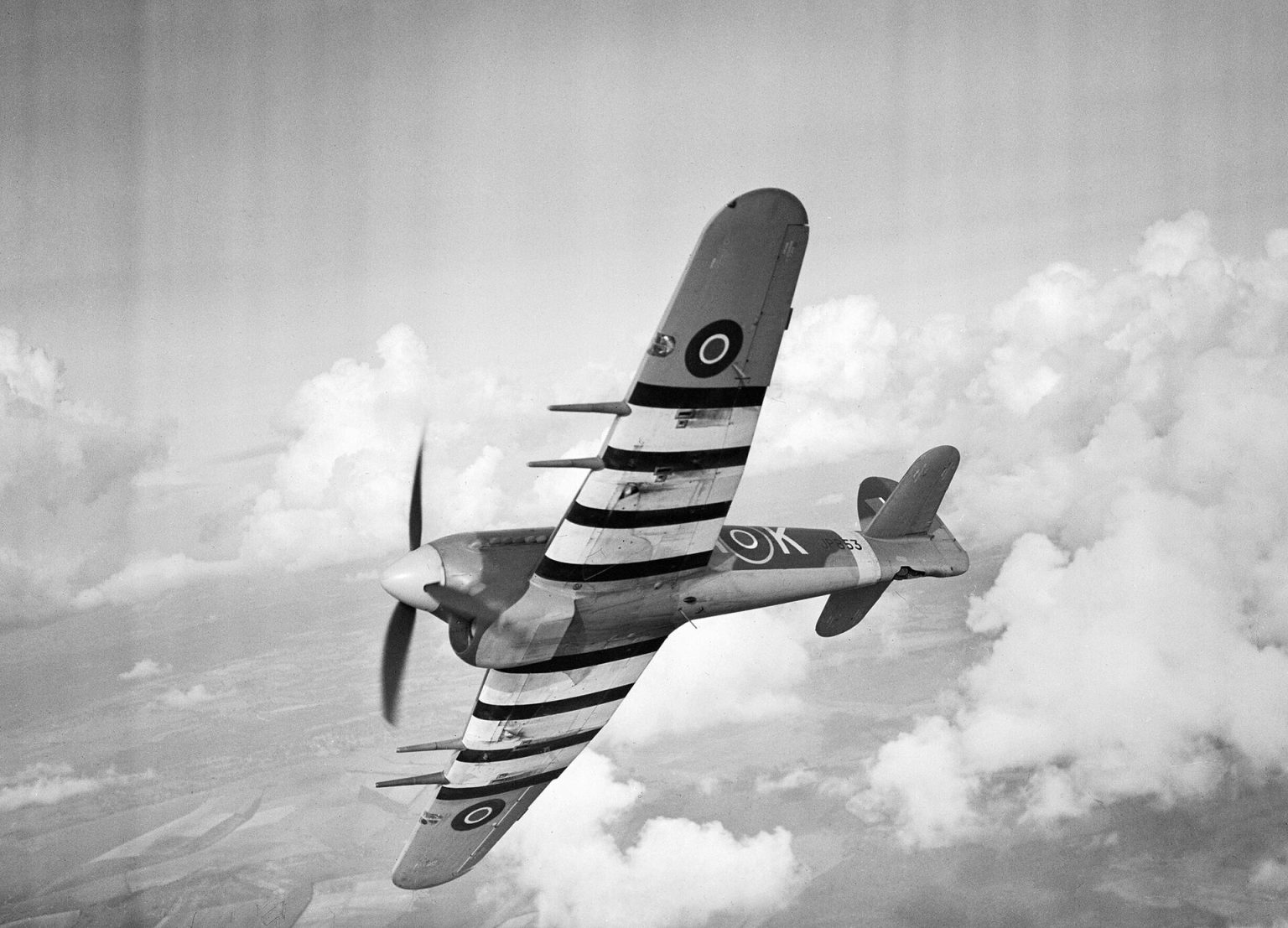 Hawker Typhoon ground-attack fighter with invasion stripes in flight