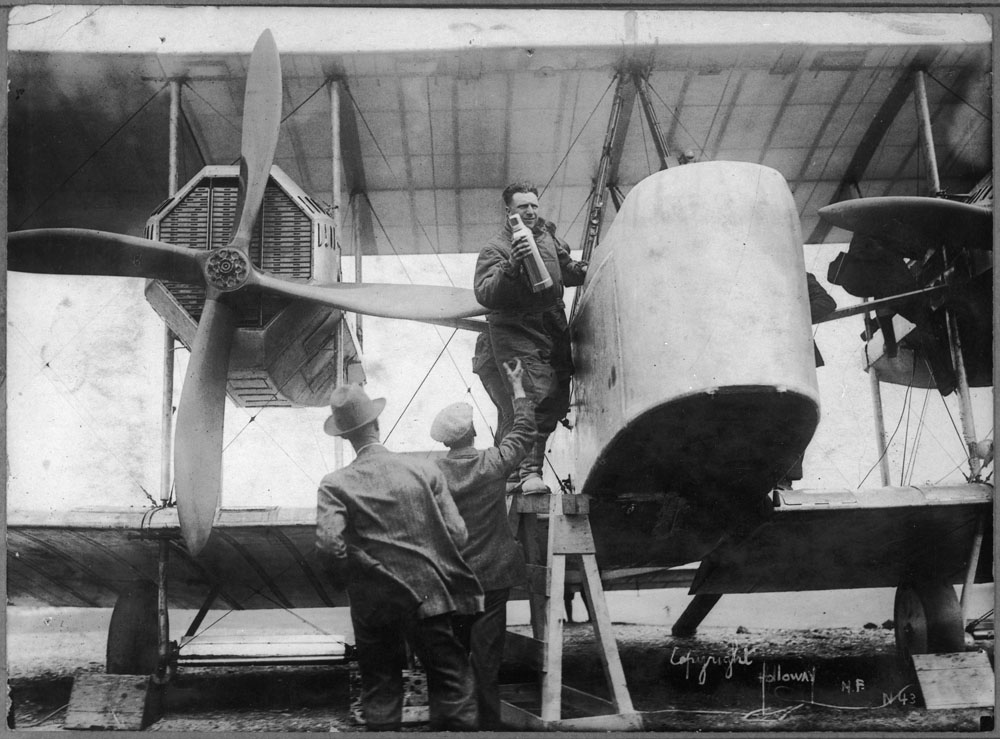 Captain John Alcock stowing provisions aboard the Vickers Vimy, Newfoundland, June 1919