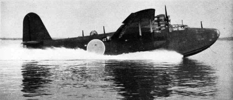 An H8K taking off, throwing a wall of spray from its deep planing hull.