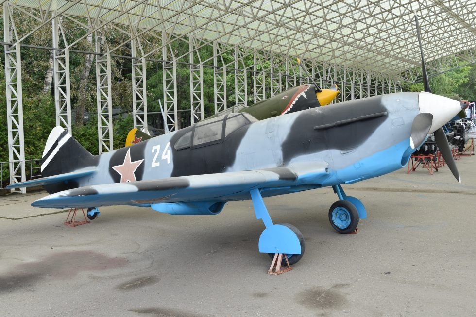 A restored LaGG-3 24 white at Victory Park, Moscow  the types slab-sided wooden fuselage clear in the light.