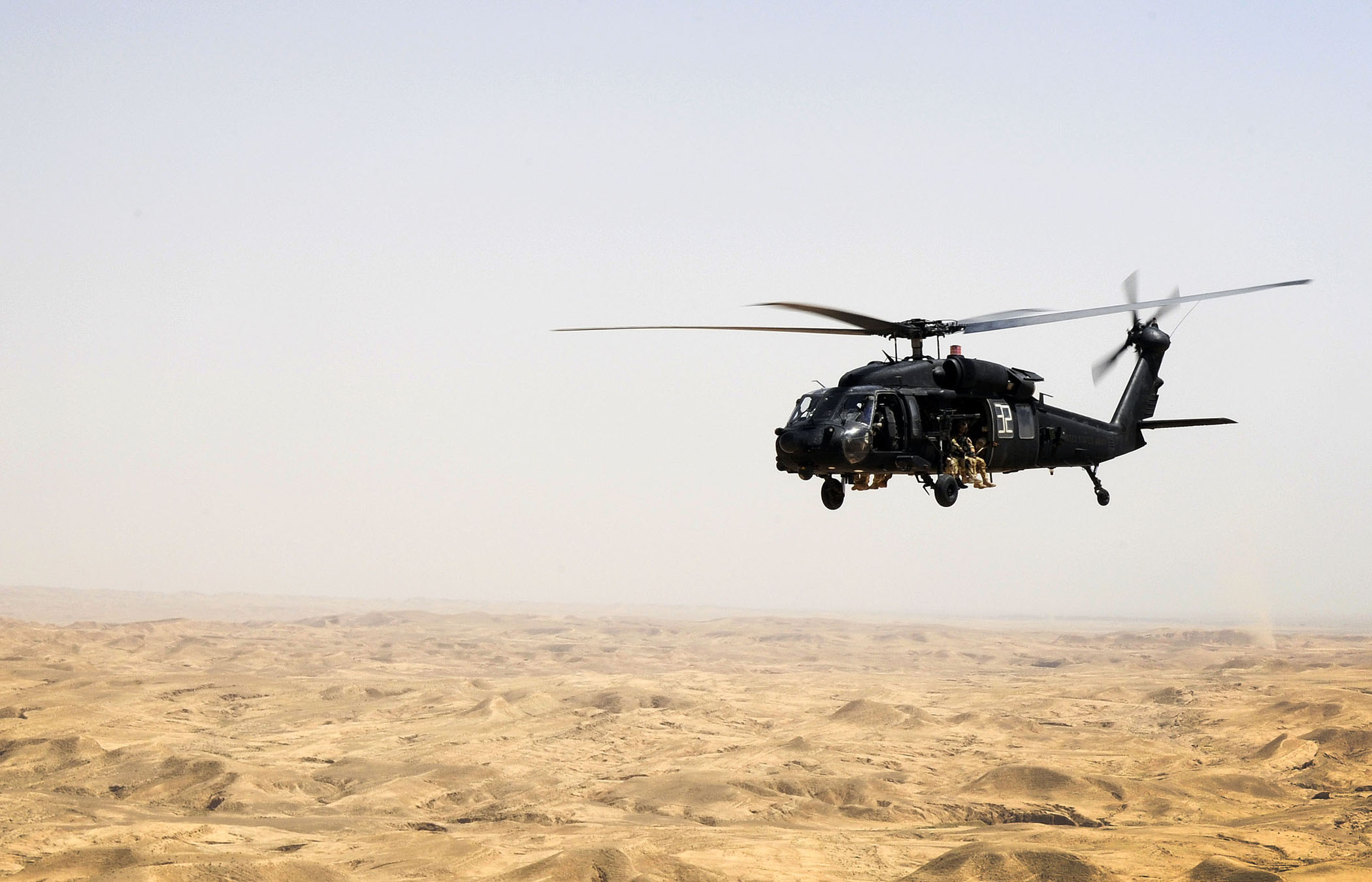 MH-60L Black Hawk over desert terrain in Iraq