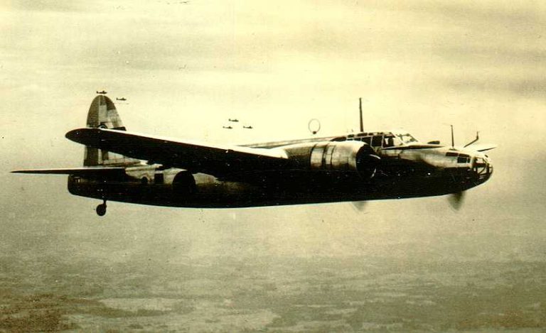 A Donryu in flight over water, showing the clean twin-radial profile of the Army Type 100.