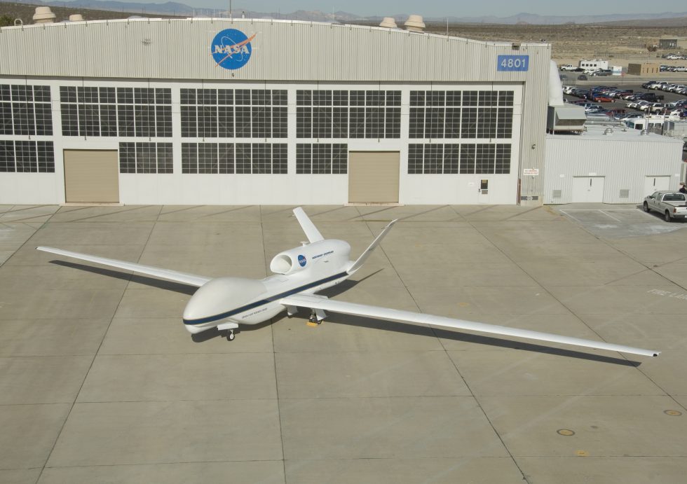 A NASA Global Hawk outside its hangar, its long, glider-like wing on full display.