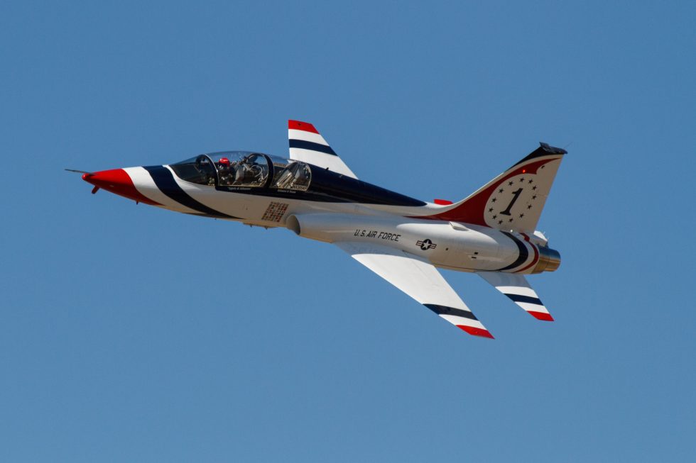 A Talon banks at an air show the area-ruled fuselage and thin wing on show.