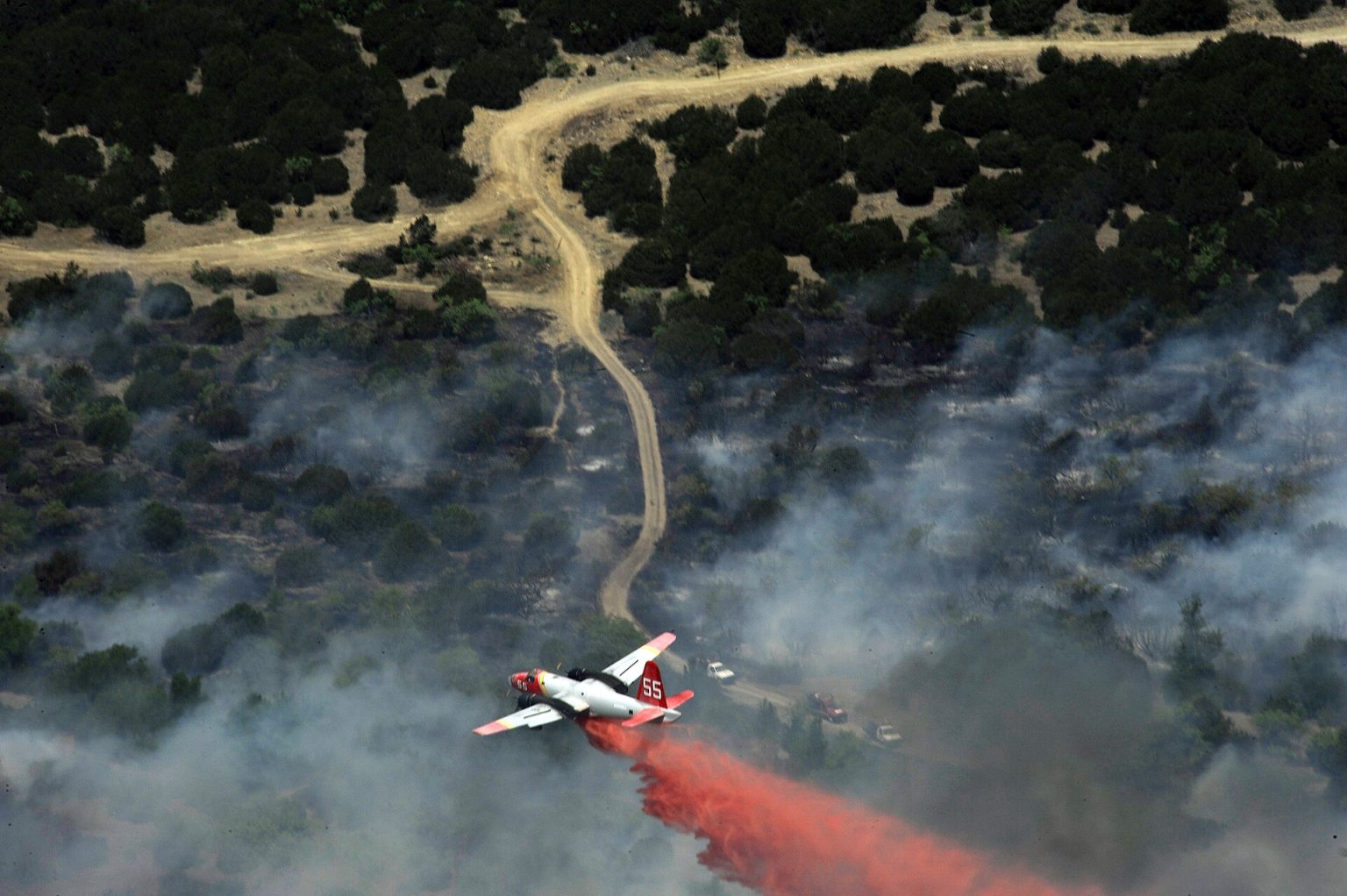 P-2 Neptune air tanker dropping retardant on a wildfire. Photo: US Air Force, public domain.