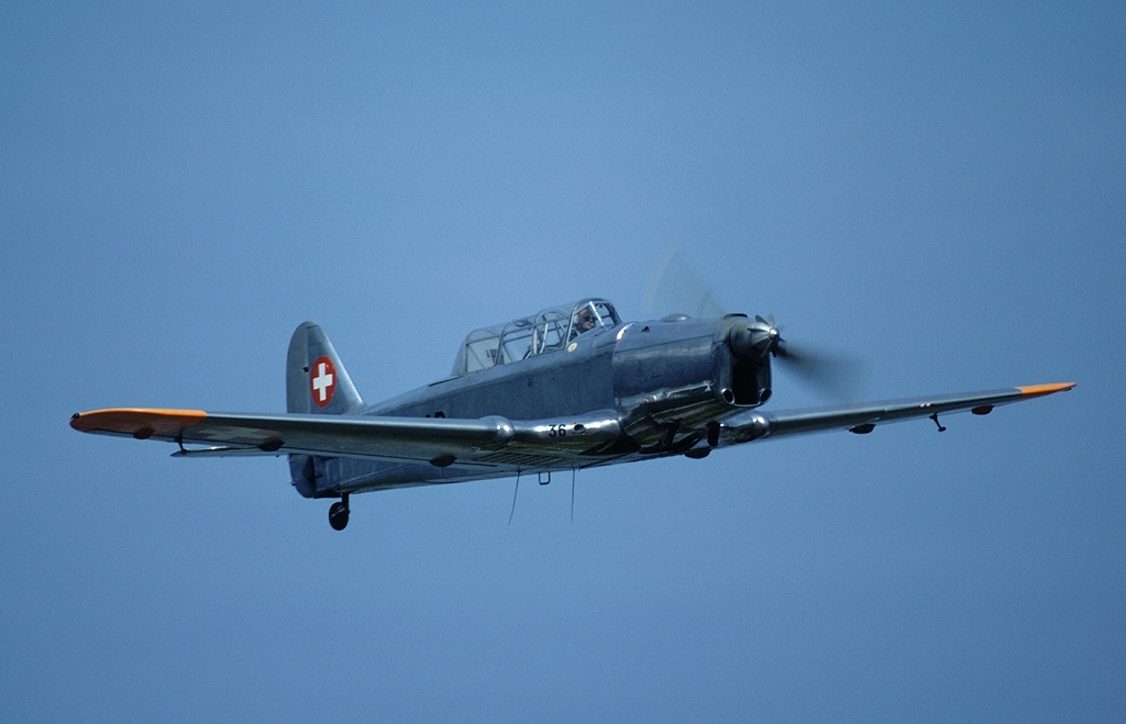 Swiss Air Force Pilatus P-2 trainer U-136 flying against a blue sky
