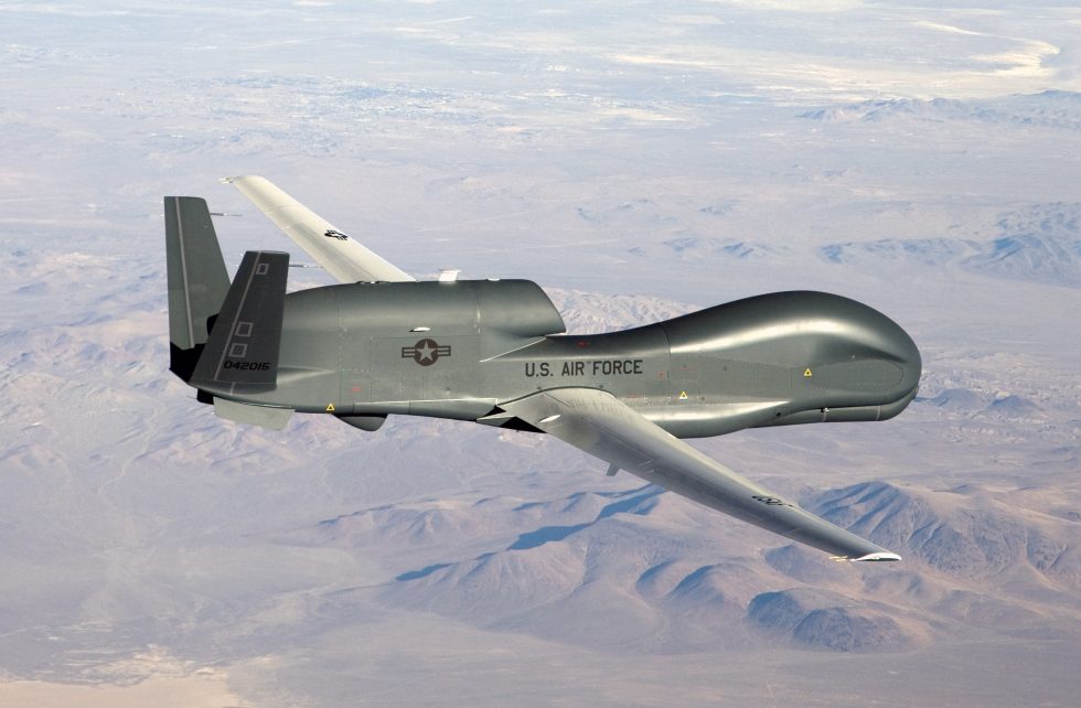 An RQ-4 Global Hawk cruising at high altitude a wingspan close to that of an airliner.