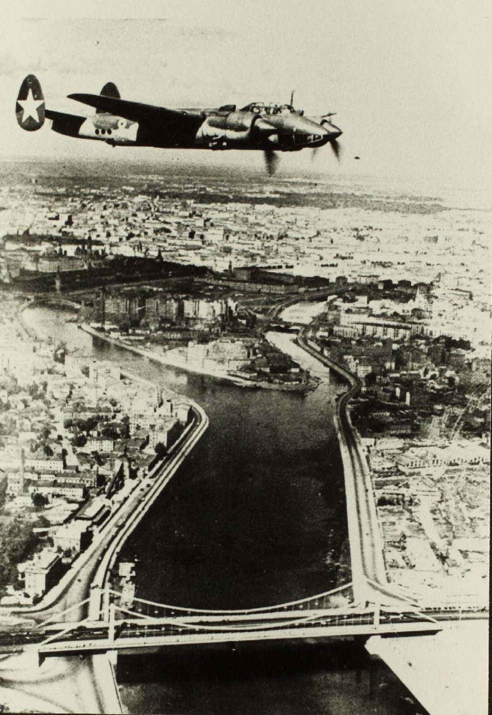 A Soviet Tu-2 in red-star markings over a European city, June 1945.