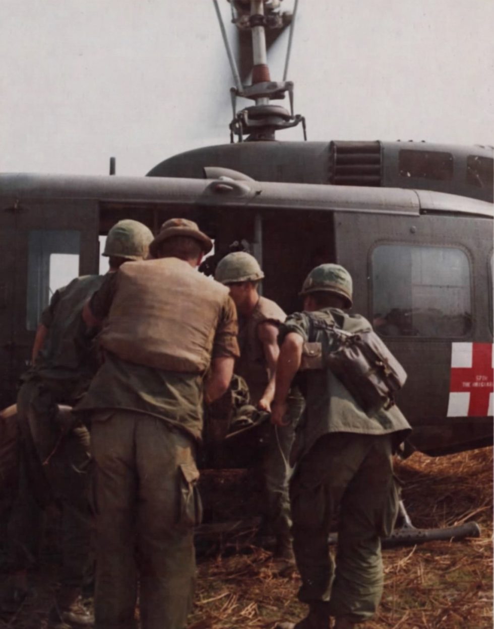 A wounded soldier is loaded onto a 57th Medical Detachment Dustoff UH-1D medevac.