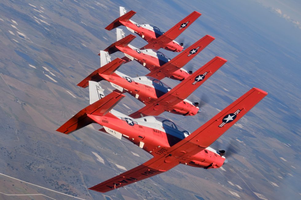 U.S. Navy T-6B Texan IIs in a four-ship formation over a military operations area in southern Texas.